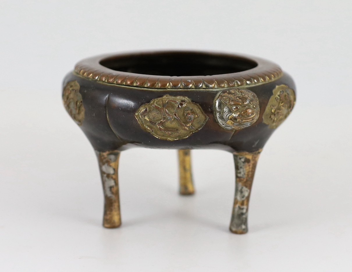 A Chinese Imperial copper alloy censer, ding, 18th century, 12cm wide 7cm high, ring handles and cover lacking, some wear.